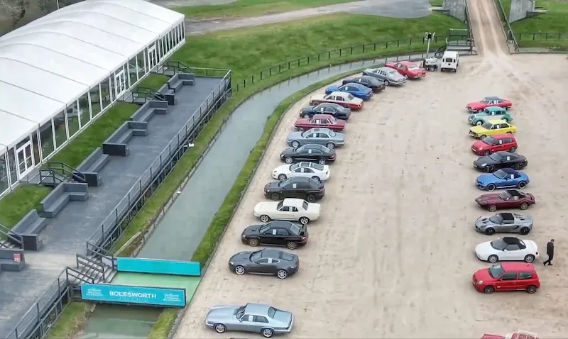Aerial drone photograph of the Hampson Auctions Bolesworth Castle venue showcasing a diverse lineup of vehicles